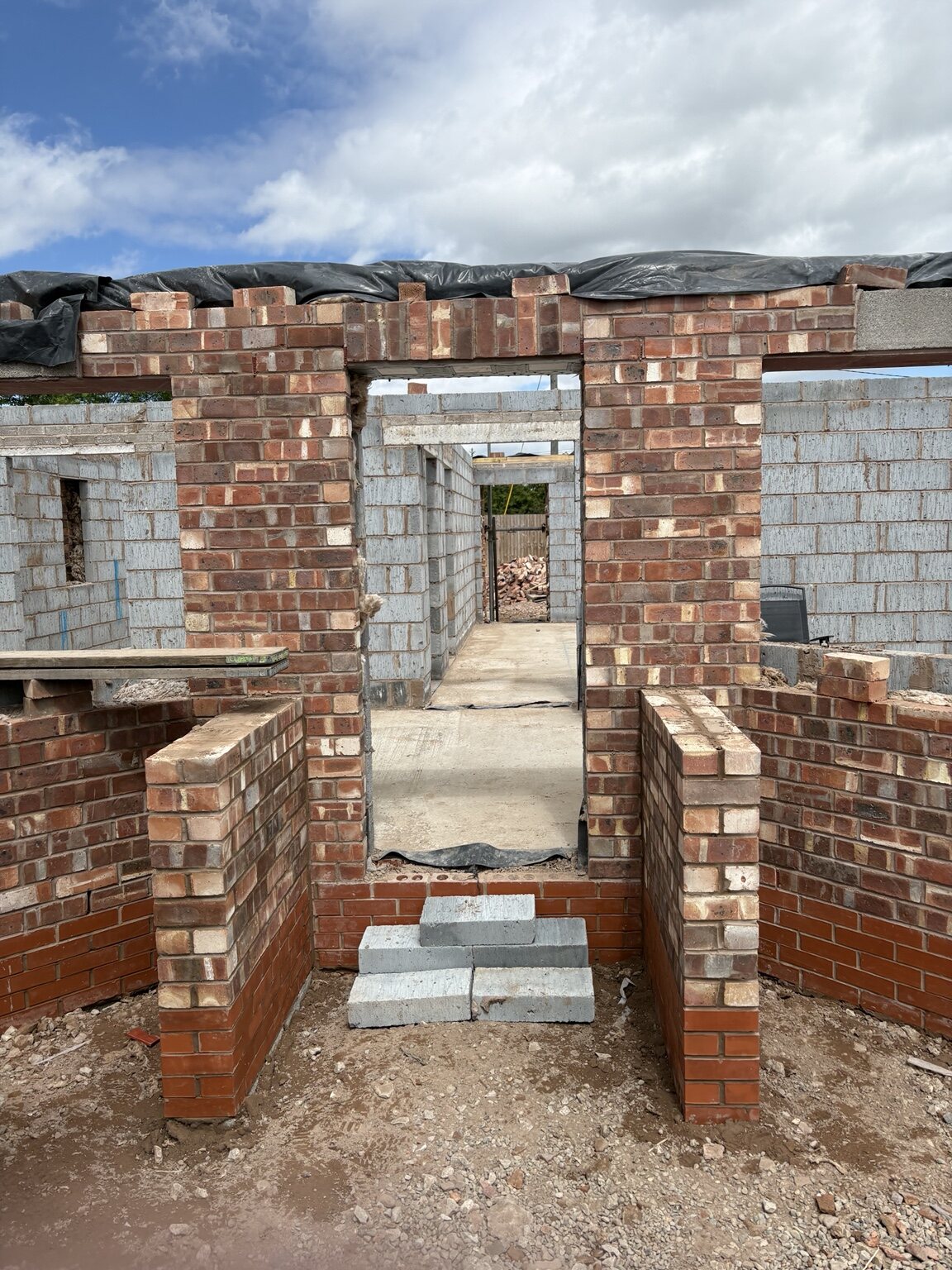 Facing brickwork and openings built up on the new-build bungalow