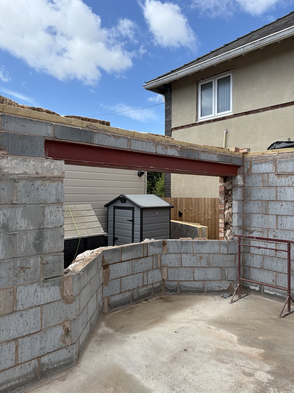 Structural steel installed across a wide opening in the new-build bungalow