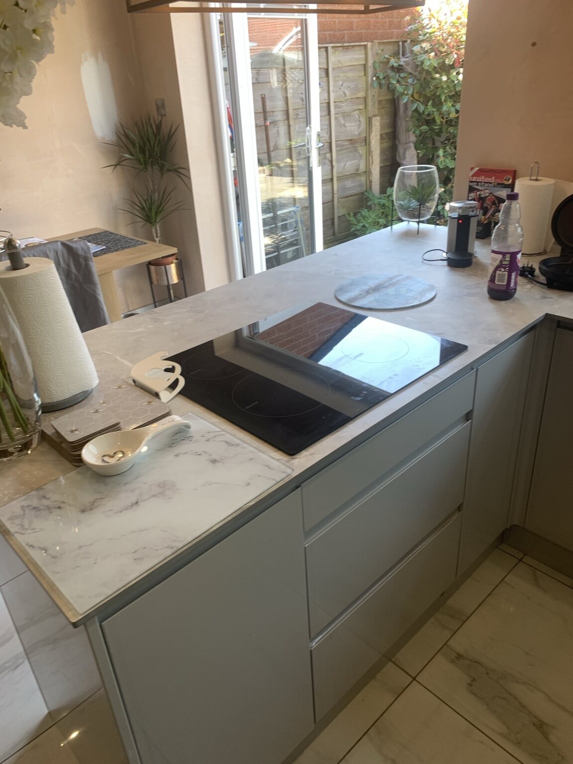 Completed fitted kitchen with island and feature lighting