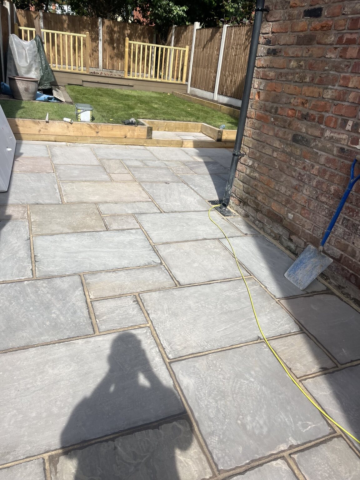 Finished sandstone patio, raised lawn and garden fencing