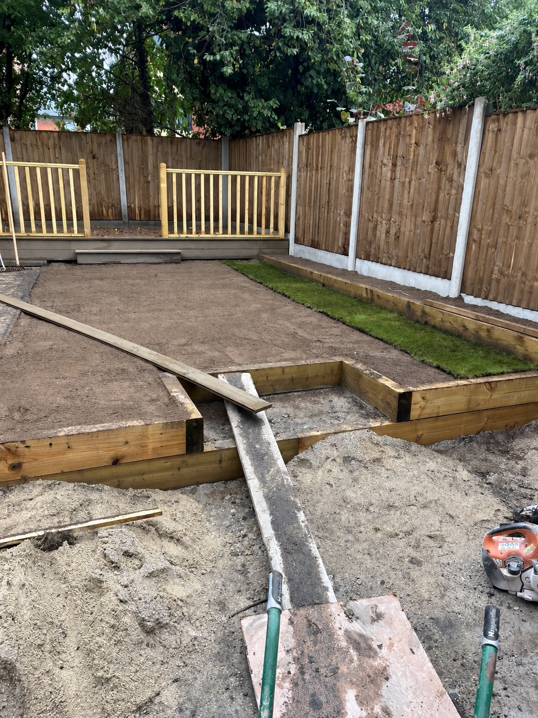 Garden groundwork, retaining timbers and fencing being installed