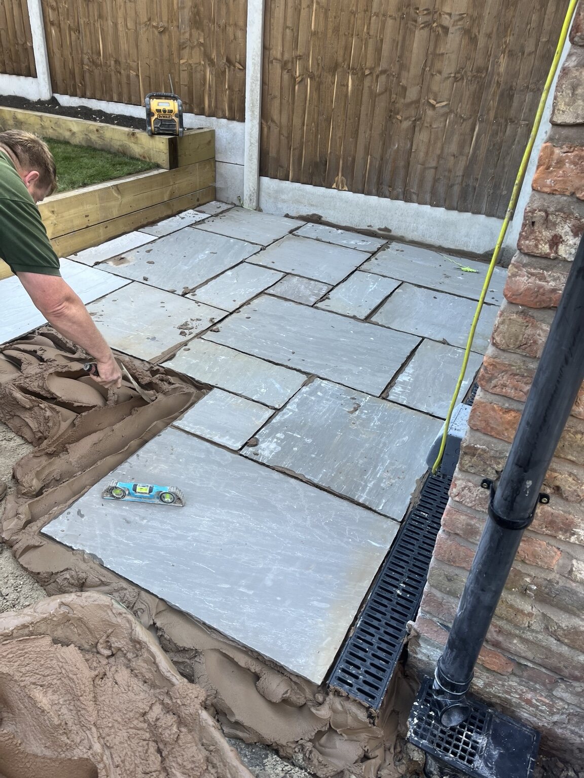 Indian sandstone paving being laid beside new channel drainage